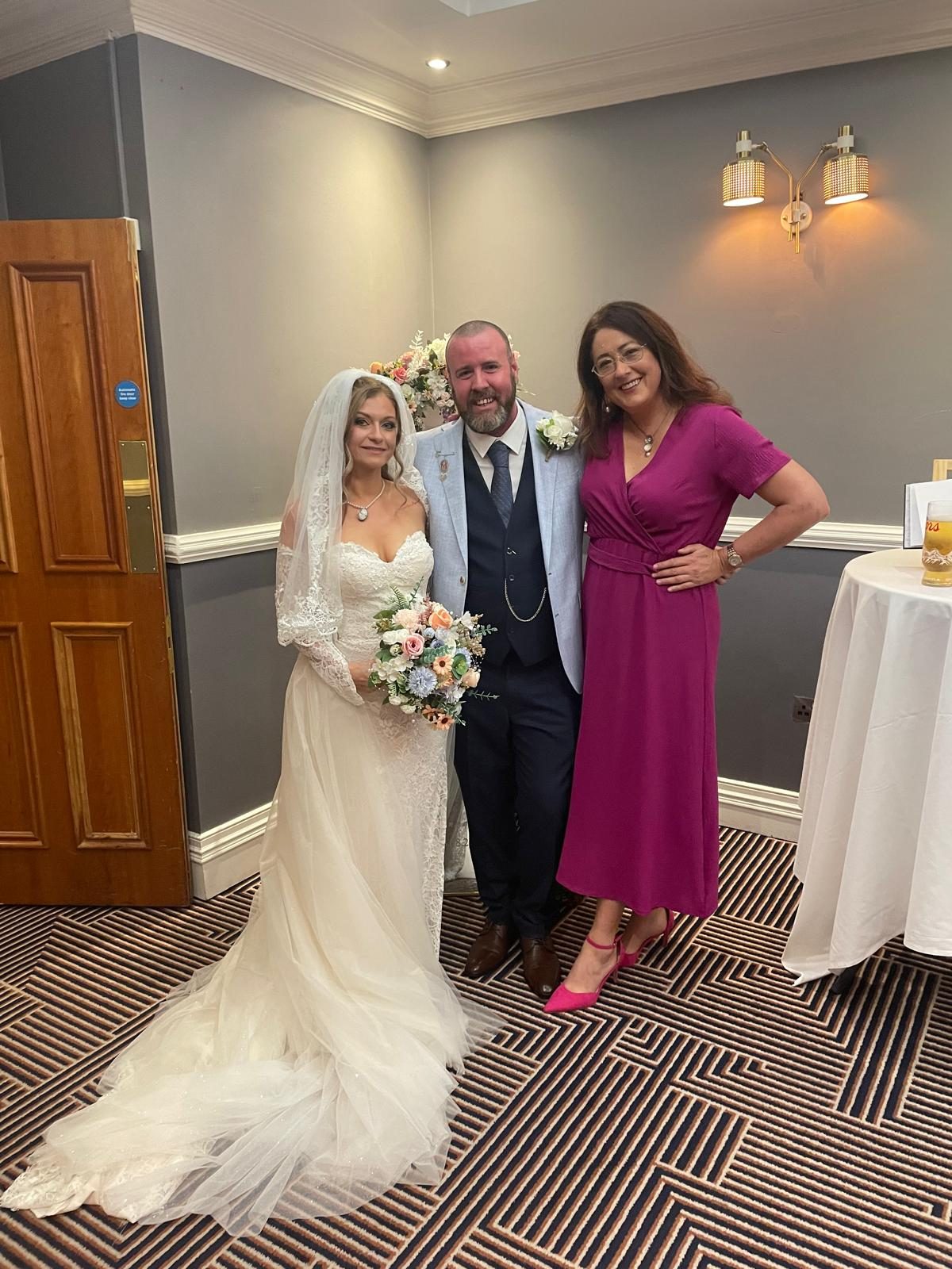 Mairead Vaughan with a couple she married